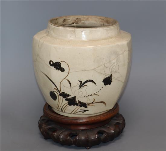 A Chinese Cizhou pottery jar, Yuan-Ming dynasty, wood stand, damaged
